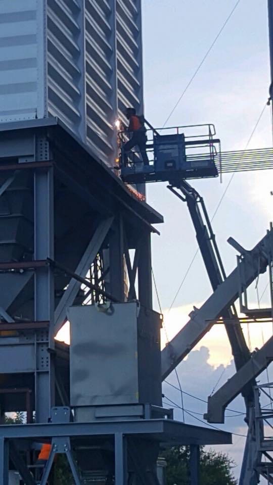 Man repairing the parts of the grain storage