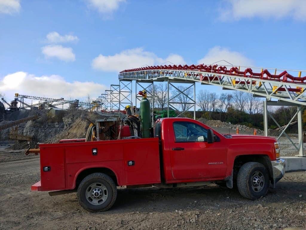 Red truck with oxygen tank in the back park in the construction site