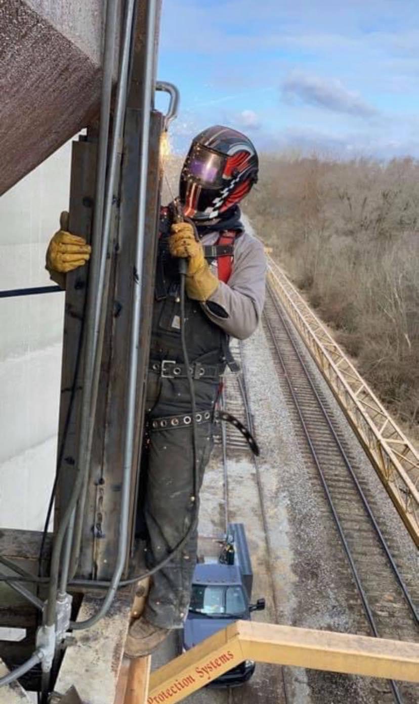 Man wearing a protective cover safely welding and repairing